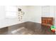 Sunlit bedroom with hardwood floors, neutral walls, and a charming wood dresser at 2576 Flat Shoals Dr, Decatur, GA 30034