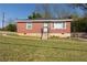 Charming brick home with a well-maintained lawn, inviting curb appeal, and a secure front entrance at 2576 Flat Shoals Dr, Decatur, GA 30034