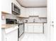 Modern kitchen featuring white cabinets, stainless steel appliances, and granite countertops for a stylish and functional space at 2576 Flat Shoals Dr, Decatur, GA 30034