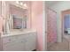 Bright bathroom with white vanity, framed mirror and shower with floral curtain at 3810 Sweat Creek Run, Marietta, GA 30062