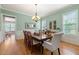 Elegant dining room with hardwood floors, a large table, and serene green walls with white trim at 3810 Sweat Creek Run, Marietta, GA 30062