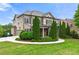Side view of beautiful home with stone and brick, complemented by a lush green lawn and landscaping at 3810 Sweat Creek Run, Marietta, GA 30062