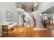 Grand foyer with a curved staircase, hardwood floors, and an elegant entryway table at 3810 Sweat Creek Run, Marietta, GA 30062