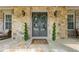 Inviting stone front porch with double doors, decorative wreaths, and stylish outdoor seating at 3810 Sweat Creek Run, Marietta, GA 30062