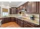A kitchen with rich wood cabinetry, granite countertops, stainless steel appliances, and a stylish backsplash at 3810 Sweat Creek Run, Marietta, GA 30062