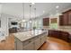 Open kitchen concept with an oversized island and breakfast bar, flowing into the living room with a fireplace at 3810 Sweat Creek Run, Marietta, GA 30062