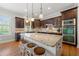 Gourmet kitchen with granite countertops, dark wood cabinets, and a large island with seating at 3810 Sweat Creek Run, Marietta, GA 30062