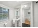 Bright bathroom with pedestal sink, large mirror, and window with blinds at 25 Standish Nw Ave, Atlanta, GA 30309