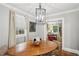 Bright dining room features a wood table with designer chandelier and a view into the living room at 25 Standish Nw Ave, Atlanta, GA 30309
