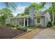 Exterior elevation showcasing a gray brick home with a charming front porch and well-manicured landscaping at 25 Standish Nw Ave, Atlanta, GA 30309