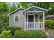 Charming home with a blue door, covered porch, and lush landscaping at 25 Standish Nw Ave, Atlanta, GA 30309