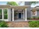 Charming front porch with white columns, a blue door, hanging lanterns, and stone walkway at 25 Standish Nw Ave, Atlanta, GA 30309