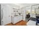 Charming butler's pantry featuring white cabinetry, a stainless steel sink, and a marble countertop at 25 Standish Nw Ave, Atlanta, GA 30309