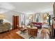 Cozy living room with hardwood floors, a red sofa, modern chairs, and elegant artwork at 25 Standish Nw Ave, Atlanta, GA 30309