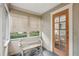 Cozy enclosed porch with bench, window, and glass door, providing a sunny spot at 25 Standish Nw Ave, Atlanta, GA 30309