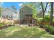 The backyard features a beautiful lawn, deck, patio, and fire pit with adirondack chairs at 3668 Spring St, Chamblee, GA 30341