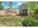 Backyard of the home with manicured lawn, patio with adirondack chairs, deck, and shed at 3668 Spring St, Chamblee, GA 30341