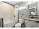 Cozy bathroom with granite countertop, neutral wall tile, and white toilet/bathtub combination at 3668 Spring St, Chamblee, GA 30341