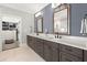 The bathroom features a double vanity, tiled floors, and access to a walk-in closet with custom shelving at 3668 Spring St, Chamblee, GA 30341