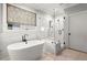 This modern bathroom features a soaking tub, a glass enclosed shower, tiled walls, and a dark faucet at 3668 Spring St, Chamblee, GA 30341