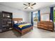 Bedroom with a wood bed frame, gray carpet, and a large window at 3668 Spring St, Chamblee, GA 30341