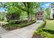 Charming brick home featuring a two-car garage and beautifully landscaped front yard with mature trees at 3668 Spring St, Chamblee, GA 30341