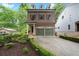 Brick two-story home featuring a two-car garage, manicured hedges and a welcoming front entrance at 3668 Spring St, Chamblee, GA 30341