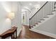 Elegant foyer features dark hardwood floors, staircase with iron railing and modern finishes at 3668 Spring St, Chamblee, GA 30341