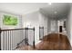 Hallway with dark hardwood floors, a staircase, and a window for natural lighting at 3668 Spring St, Chamblee, GA 30341