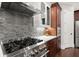 Stainless steel range hood and modern range, complemented by stylish backsplash and cabinets at 3668 Spring St, Chamblee, GA 30341