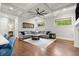 Open living room featuring coffered ceilings, hardwood floors, large windows, and a comfortable sectional sofa at 3668 Spring St, Chamblee, GA 30341