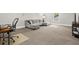 A spacious living room with grey carpeting, a large sectional sofa, and an office chair at a wooden desk at 3668 Spring St, Chamblee, GA 30341