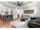 Open-concept living room with stylish furnishings, hardwood floors, and seamless access to the kitchen at 3668 Spring St, Chamblee, GA 30341