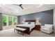 This main bedroom features a beautiful tray ceiling, hardwood furniture, and large sunny windows at 3668 Spring St, Chamblee, GA 30341