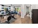A recreation room with home gym equipment, hardwood floors, a blue sectional sofa, and patio access at 3668 Spring St, Chamblee, GA 30341