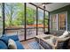 A screened porch features wood floors, an outdoor seating area, and a ceiling fan at 3668 Spring St, Chamblee, GA 30341