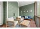 The cozy screened porch is furnished with comfortable chairs, a sofa, and a coffee table at 3668 Spring St, Chamblee, GA 30341