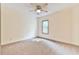 Carpeted bedroom with ceiling fan and a window with natural light at 3688 E Bay St, Duluth, GA 30096