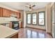 This kitchen features wood floors, stainless steel appliances, and natural light from windows at 3688 E Bay St, Duluth, GA 30096