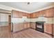 A kitchen featuring a gas range, light countertops, and wood cabinets at 3688 E Bay St, Duluth, GA 30096