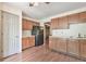 Kitchen with wooden cabinets, laminate flooring, and essential appliances at 3688 E Bay St, Duluth, GA 30096