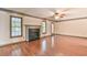 Bright living room with fireplace, hardwood floors, and large windows for natural light at 3688 E Bay St, Duluth, GA 30096