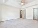 Spacious main bedroom featuring neutral carpeting, a ceiling fan, and ensuite bathroom access at 3688 E Bay St, Duluth, GA 30096
