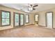 Spacious main bedroom with ensuite bathroom access, carpet flooring, and double doors to backyard at 3688 E Bay St, Duluth, GA 30096