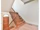 Elegant foyer staircase featuring hardwood steps and a wooden handrail at 3688 E Bay St, Duluth, GA 30096