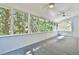 Large sunroom featuring carpet, several windows, and outdoor views at 3688 E Bay St, Duluth, GA 30096