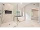 Modern bathroom featuring a glass-enclosed shower and a standalone tub with a window view at 3801 Bays Ferry Trl, Marietta, GA 30062