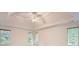 Spacious bedroom with tray ceiling, fan, and ample natural light from the windows at 3801 Bays Ferry Trl, Marietta, GA 30062
