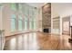 Bright living room featuring hardwood floors, a stone fireplace, and large windows at 3801 Bays Ferry Trl, Marietta, GA 30062