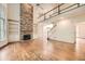 Inviting living room with hardwood floors, stone fireplace, and a view of the second-floor landing at 3801 Bays Ferry Trl, Marietta, GA 30062